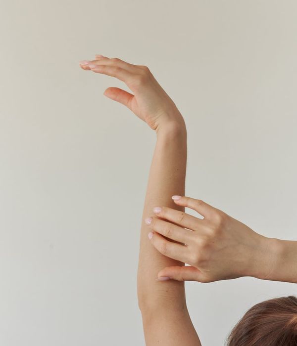 Woman in a graceful yoga pose with mango colored light accents.